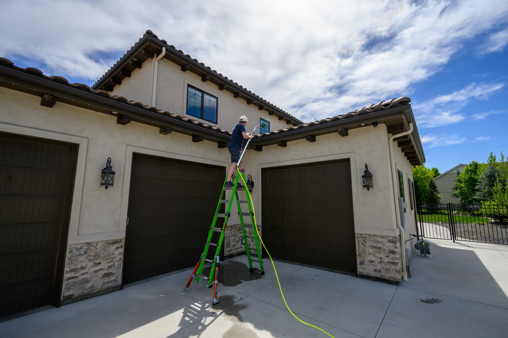 Upper-story residential window cleaning from a ladder